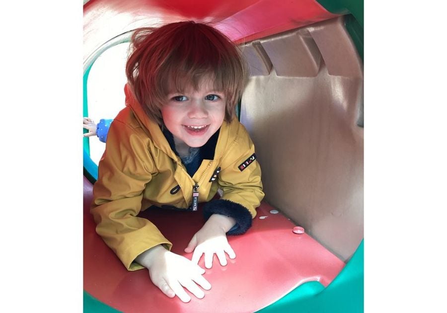 little boy crawling through play tunnel