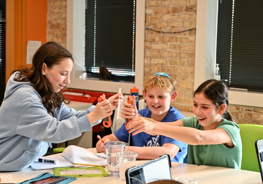 three kids doing a science experiment