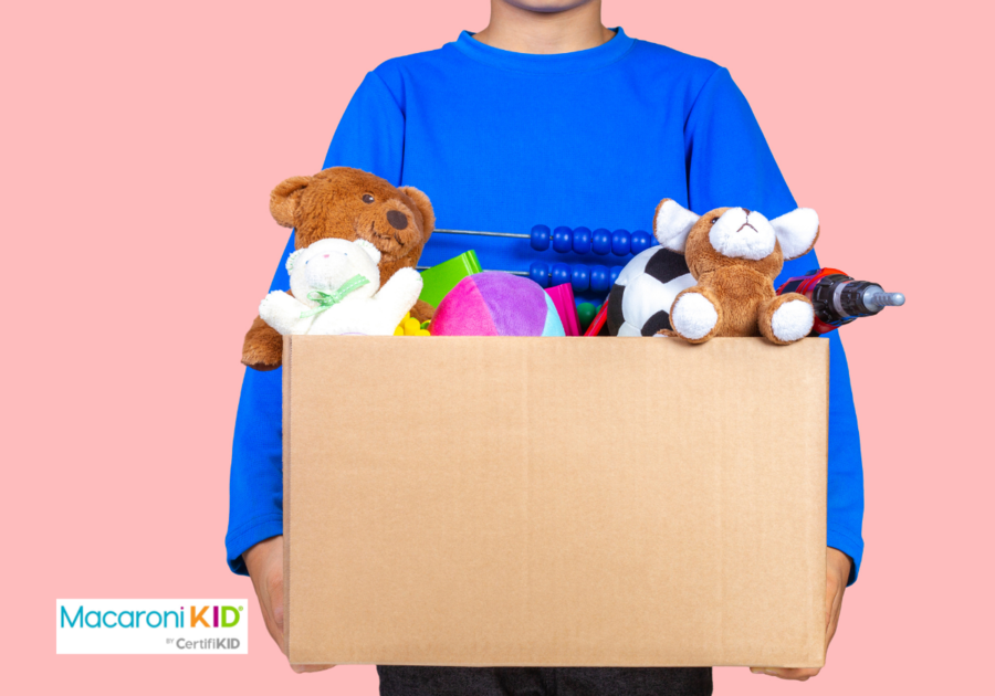 child holding box of old toys