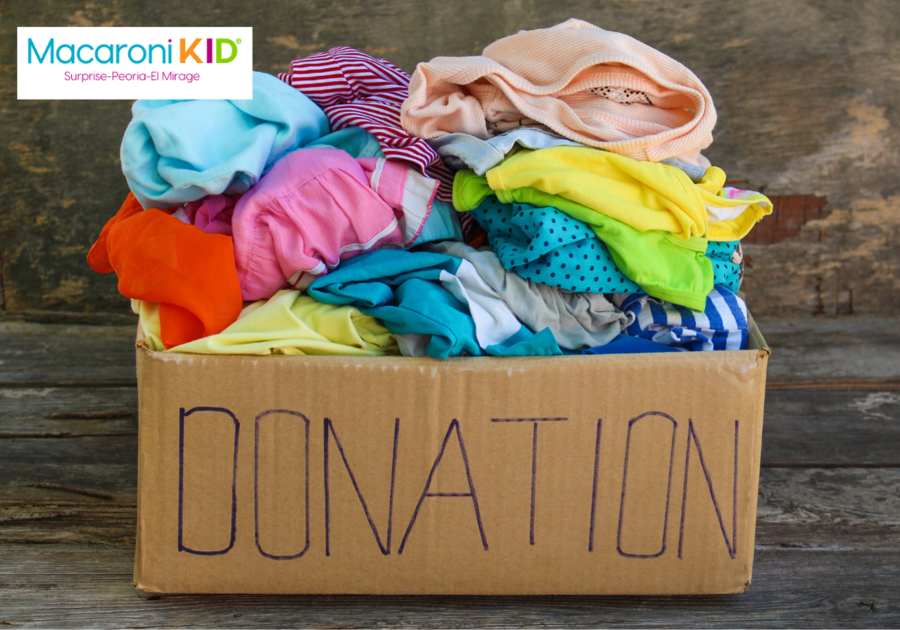 Clothing donations piled in a cardboard box labeled Donation