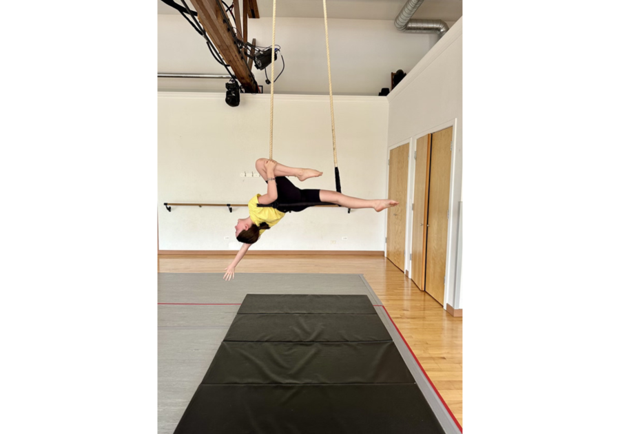 girl hanging from trapeze