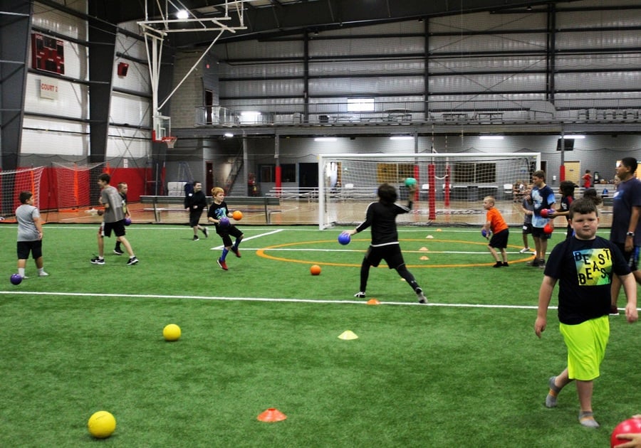 Kids playing dodgeball indoors