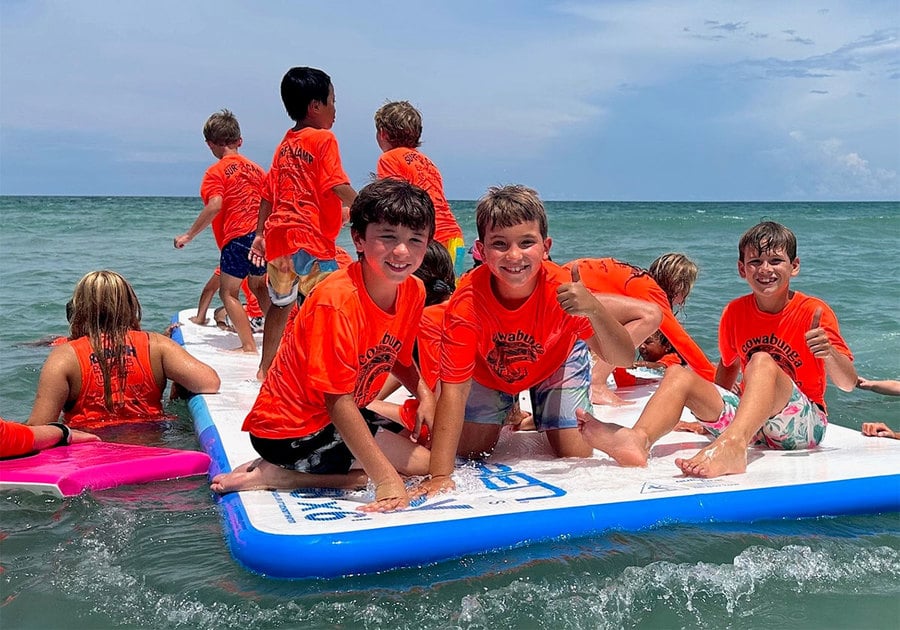 Cowabunga campers sitting on a raft in the ocean