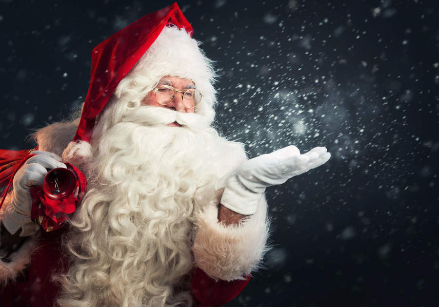 santa with left hand levitated and sparkles coming from hand in a magical way
