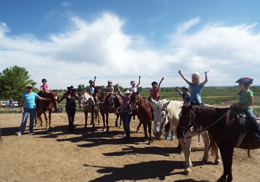 excited children on horseback at Big Horn Stables summer camp