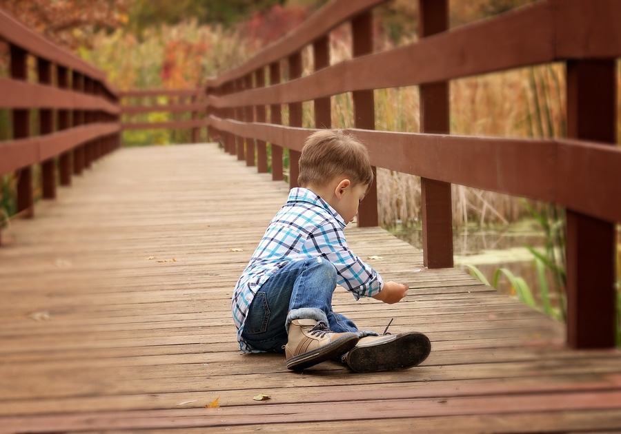 Young boy sitting on a dock