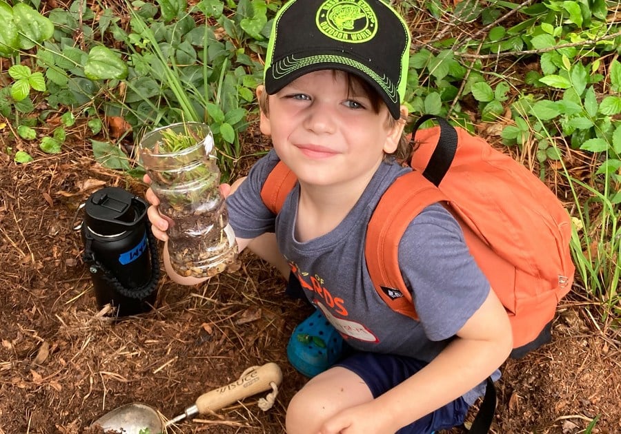 photo of boy with dirt collection