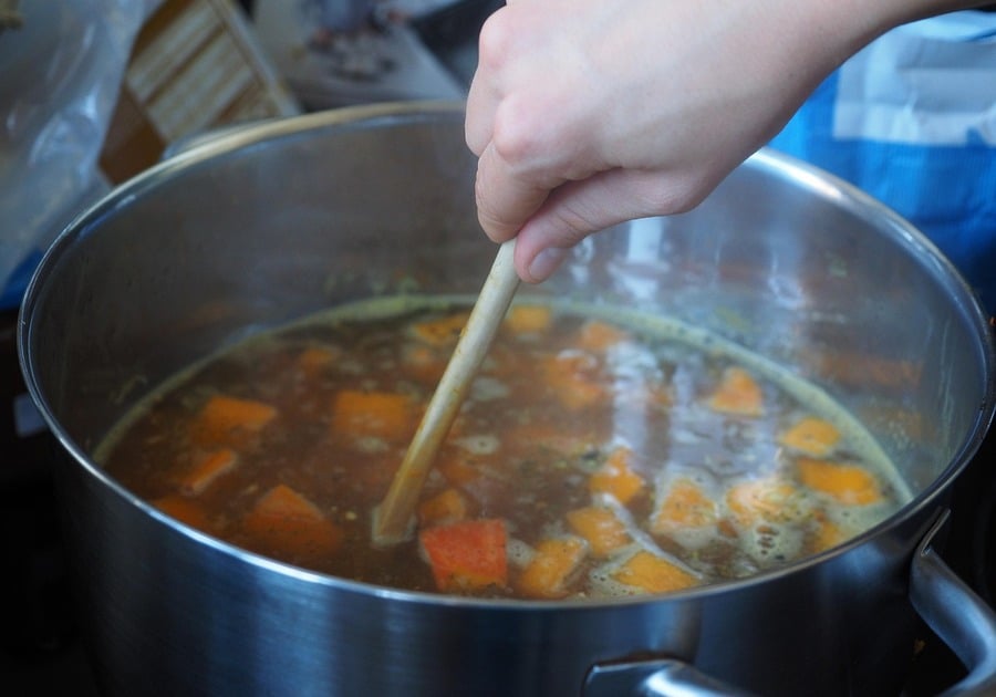 Stirring a pot of vegetables for a broth