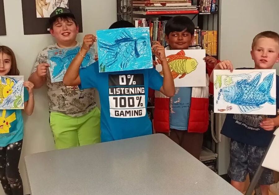 Students showing their artwork