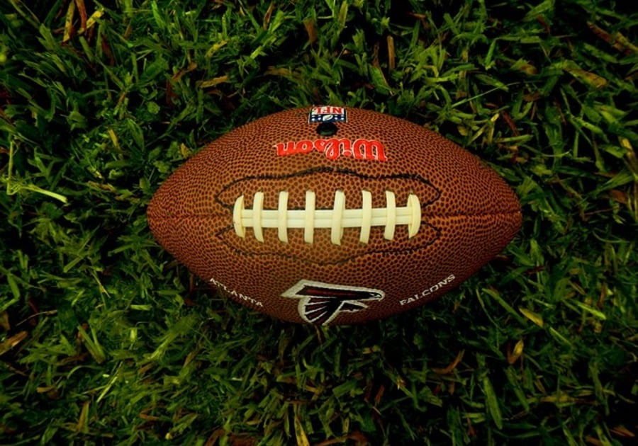 a football in the middle of the grass