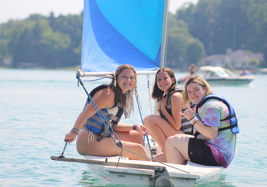 three teen girls sailing