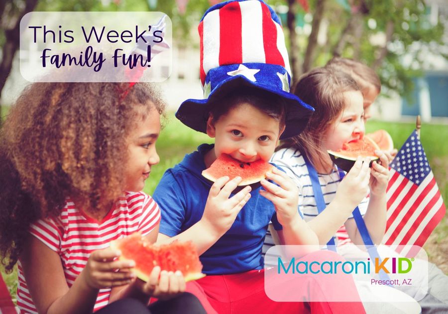 Kids dressed for the 4th of July eating watermelon slices.