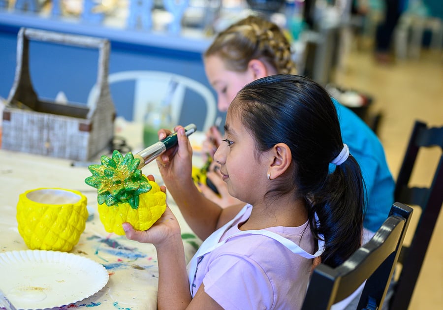 girl painting a ceramic pineapple at Createry Workshop Highlands Ranch