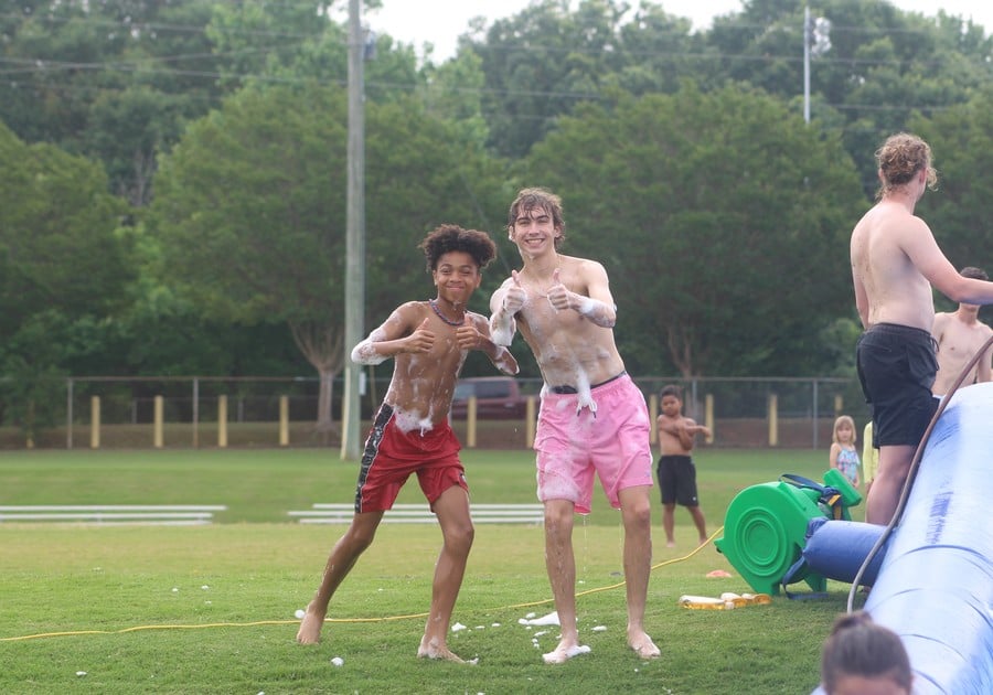 photo of two teenage males with soap on sports field