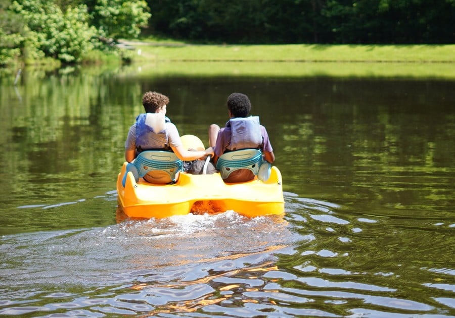 Photo of two male campers in a paddle boat