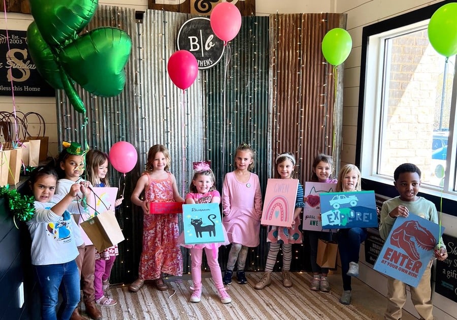 Group of kids holding up completed birthday projects