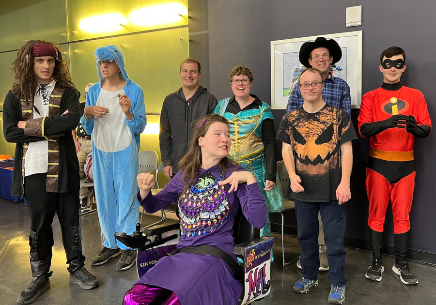 group of teens and adults dressed in Halloween costumes