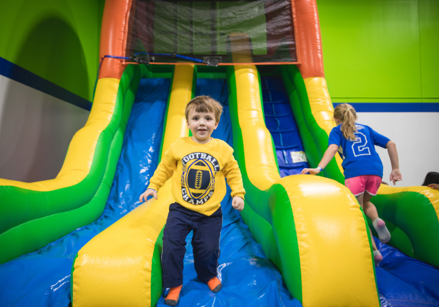 little boy coming off inflatable slide