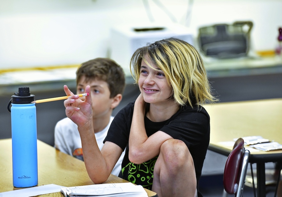 students sitting at desks in classroom