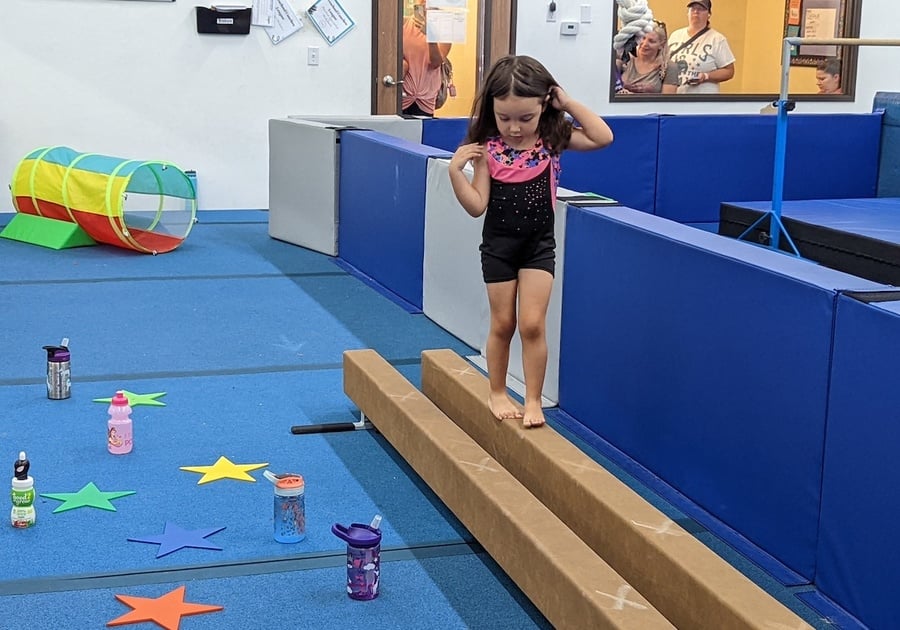 Preschooler on a low balance beam