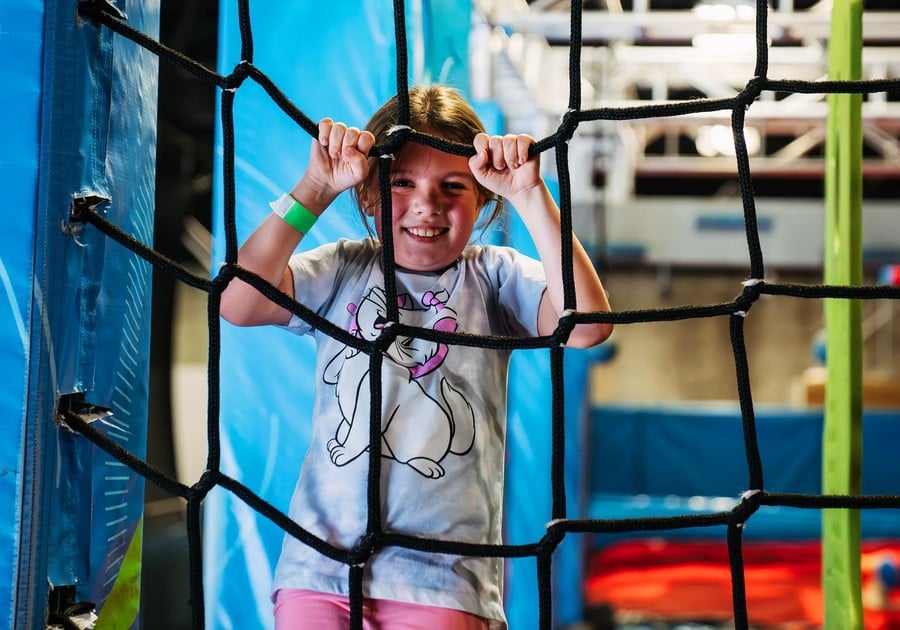 girl holding onto netting