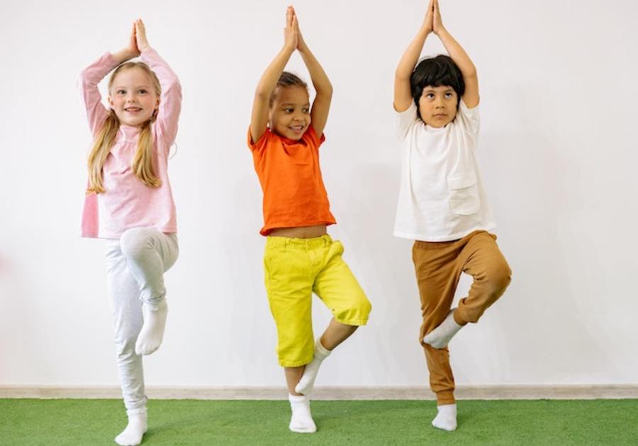 three kids doing tree pose