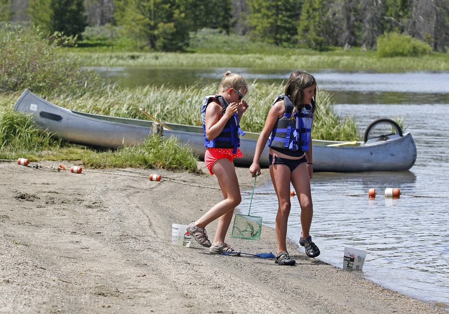 two children and a canoe on the shore of Steamboat Lake at Steamboat Lake State Park