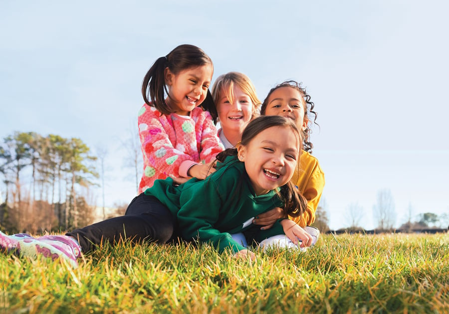 Four girls playing in grass