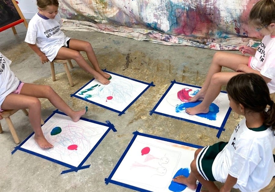 female campers painting with their feet