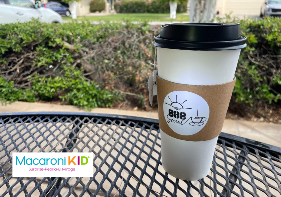 A to go coffee cup on a table in a front patio