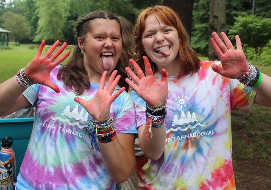 teens with red paint on hands