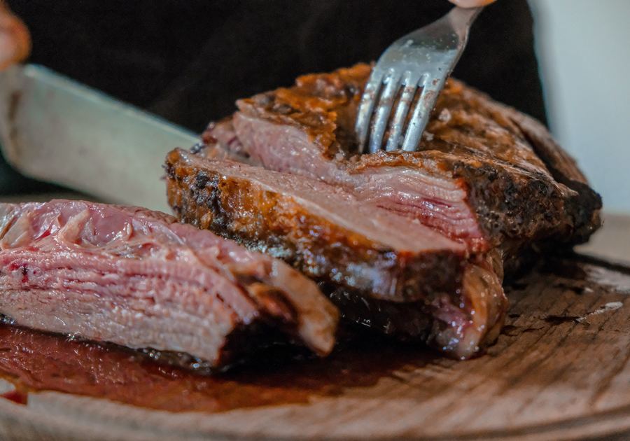 carving pot roast on a cutting board