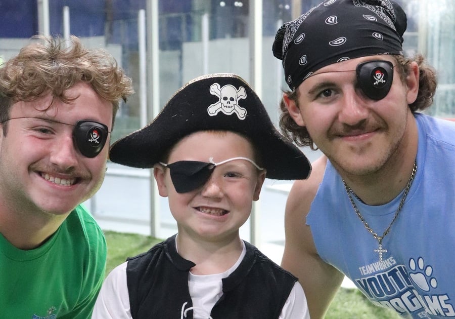 Boy and camp counselors pretending to be pirates