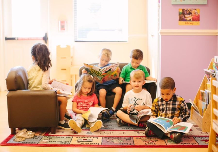 6 preschoolers reading in a reading nook