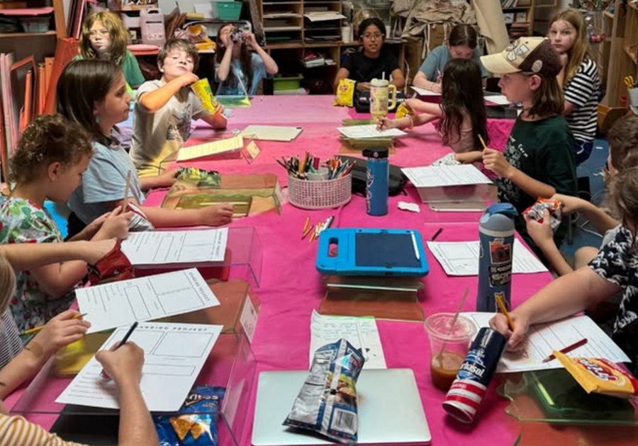 campers working on projects around a table