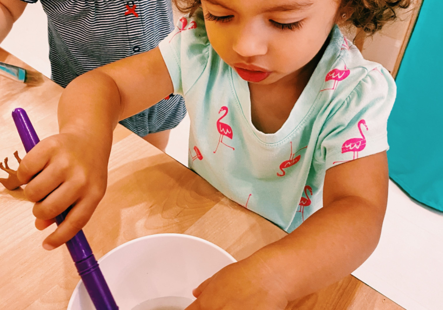toddler mixing something in a bowl