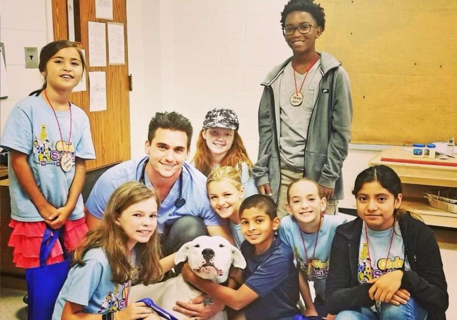 Kids, doctor, and dog in a Treasure Coast Club SciKidz classroom