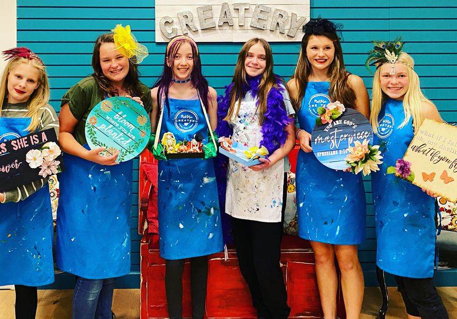 teens showing off signs created at Createry Workshop birthday party
