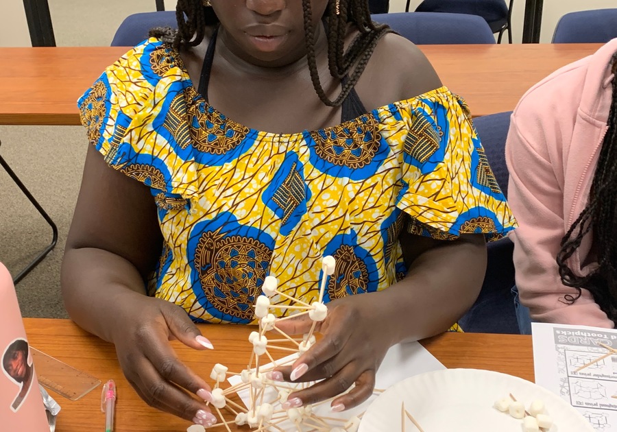 Girl building with toothpicks