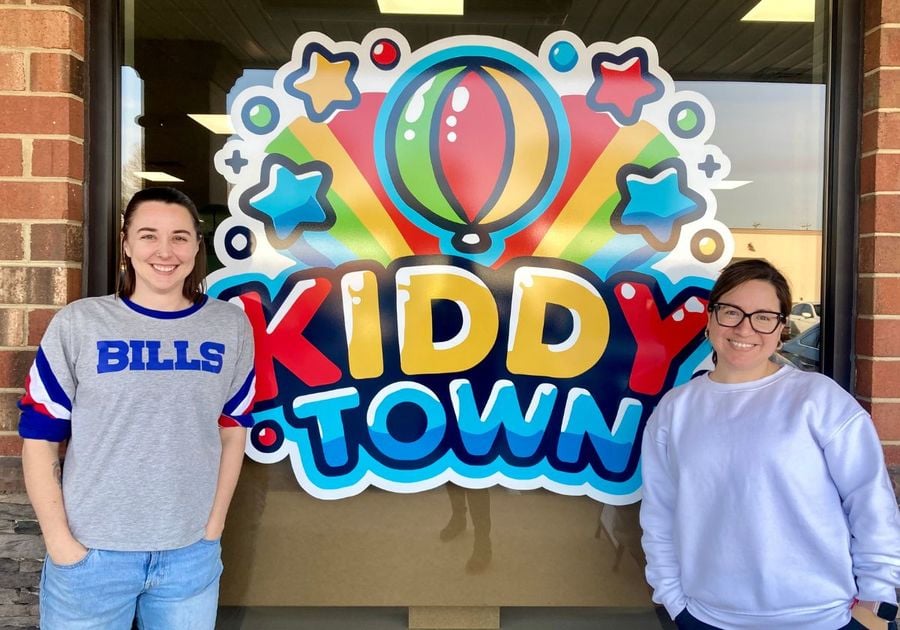 Kiddy Town Owners Pose by Front Window