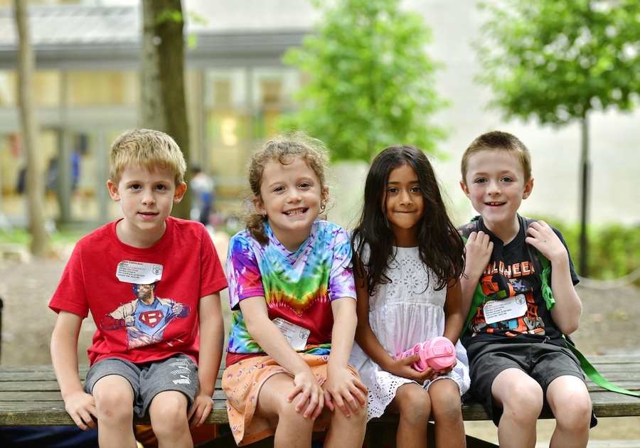 kids sitting outside on a bench