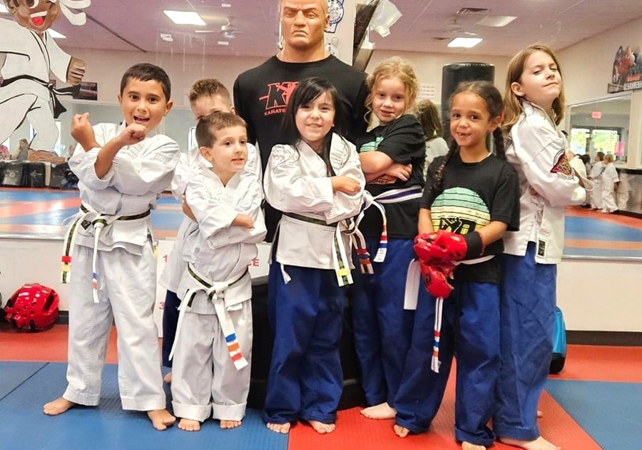 photo of kids in karate uniforms, posing for pic