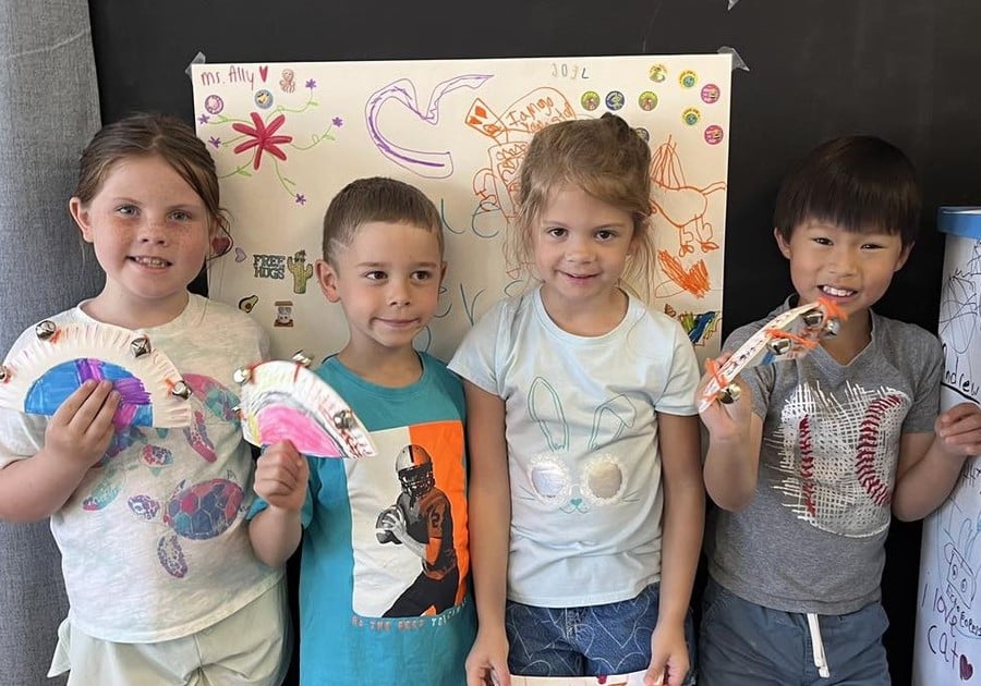 Photo of young campers posing for photo holding projects