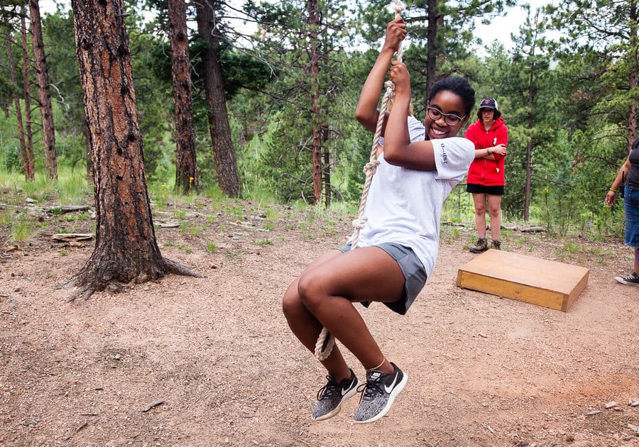 swinging on a rope at Girl Scouts of Colorado summer cmap