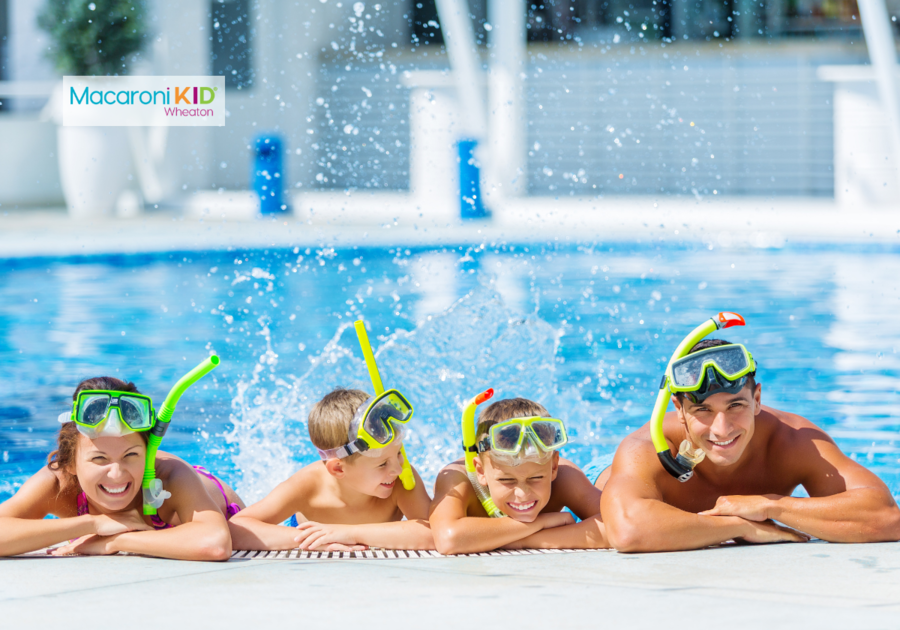 Family in a pool with snorkel mask splashing water & swimming