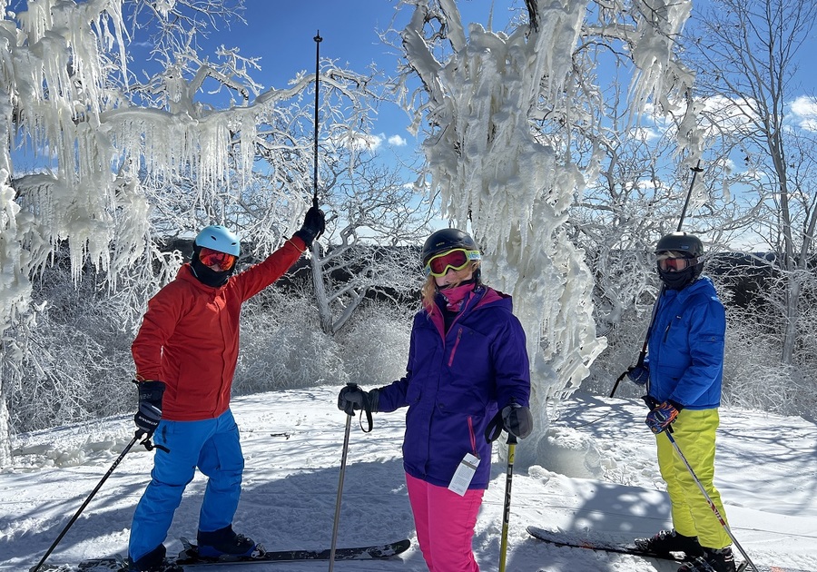 three skiiers