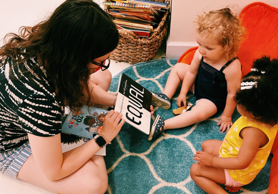 parent reading a board box to a toddler