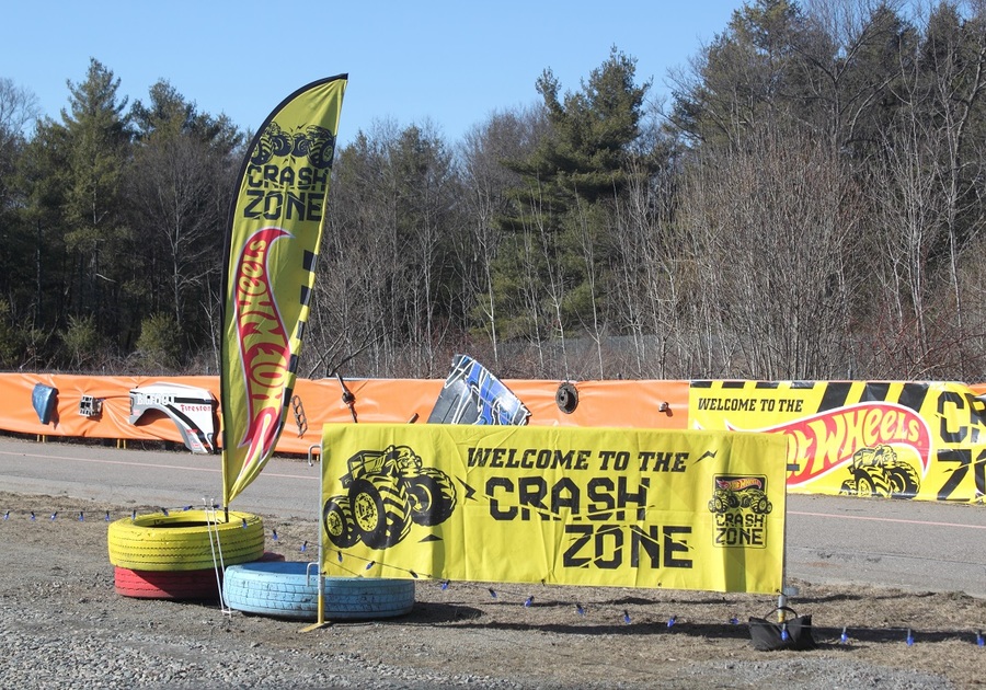 Banner reading Welcome to the Crash Zone next to tires on ground