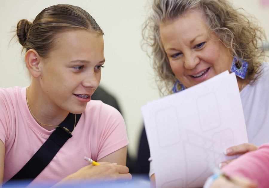 Student and teacher looking at paper