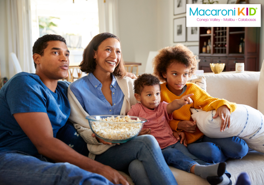 Family watching a show eating popcorn